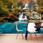 Fototapetti - Orient - landscape with Buddha sculpture on a background of a waterfall and exotic forest